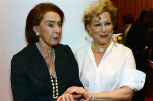 This Thursday, Dec. 17, 2015 photo provided by Jazz at Lincoln Center shows, JALC board member Mica Ertegun, left, and Bette Midler, at "Big Band Holidays" concert at the Rose Theater, in New York. The Queen of Soul, Aretha Franklin, made a surprise appearance at the House of Swing, helping the Jazz at Lincoln Center Orchestra usher in the holiday season at their first concert in their newly refurbished home. The concert followed a ribbon-cutting ceremony hosted by Midler to open the new Mica and Ahmet Ertegun Atrium at Jazz at Lincoln Center. (Frank Stewart/Jazz at Lincoln Center via AP)