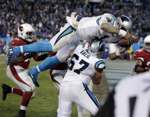 Carolina Panthers' Cam Newton leaps in the end zone for a touchdown run during the second half the NFL football NFC Championship game against the Arizona Cardinals, Sunday, Jan. 24, 2016, in Charlotte, N.C. (AP Photo/Chuck Burton)