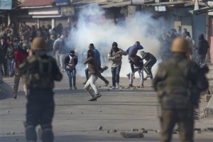 Kashmiri Muslim protesters throw bricks and stones at Indian policemen during a protest in Srinagar, Indian controlled Kashmir, Friday, Feb. 19, 2016. Government forces fired tear gas and pellet guns to stop hundreds of rock-throwing Kashmiri youths in Indian-controlled Kashmir after Friday prayers. They were protesting the arrest of a Delhi University lecturer, S.A.R. Geelani, and a student leader of the Jawaharlal Nehru University (JNU) on charges of sedition for raising anti-India slogans. Geelani also allegedly criticized the 2013 hanging of a Kashmiri man Afzal Guru convicted of attacking Indian Parliament. (AP Photo/Dar Yasin)