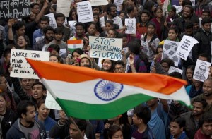 Indian students wave an Indian flag and shout slogans during a protest at the Jawaharlal Nehru University against the arrest of a student union leader in New Delhi, India, Thursday, Feb. 18, 2016. Scenes of protest that rocked a New Delhi university this week spread across the country Thursday, with students and teachers from cities including Bangalore, Kolkata and Chennai joining demands for the release of a student leader arrested on sedition charges. (AP Photo/Tsering Topgyal)