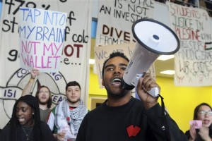 In this Thursday, Nov. 12, 2015, photo, University of Massachusetts Amherst student Evandro Tavares speaks to students gathered to highlight issues from racial inclusion to student debt, during a march at the Student Union on the UMass campus in Amherst, Mass. UMass administrators held a "listening session" the following day where students expressed their need to see more faculty of color in the classroom, those who are more familiar with their experiences as students of color. (Carol Lollis/Daily Hampshire Gazette via AP)